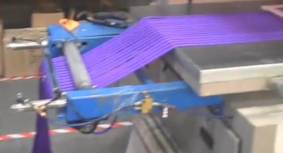 Lanyards being fed into a printing machine