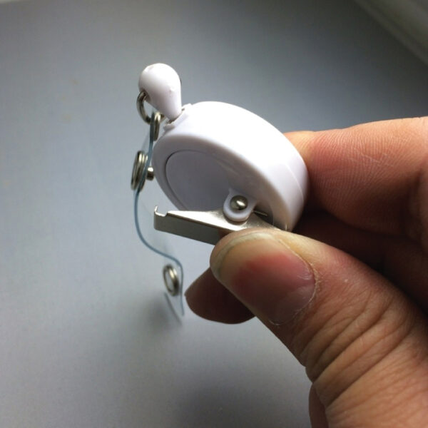 Back of alligator clip retractable reel - Actually it is a bulldog. Bites into a pocket hem.